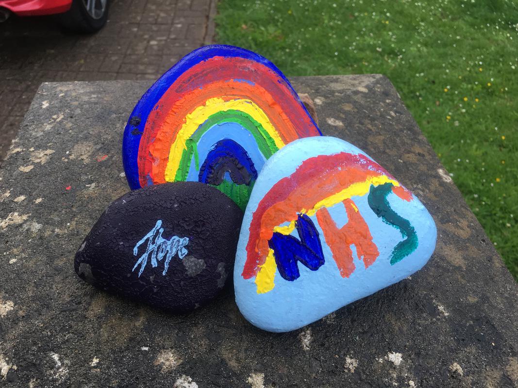 Painted pebbles, a rainbow of hope, the word hope and support for the National Health Service, seen on a gatepost of a house on Cog Road, Sully.