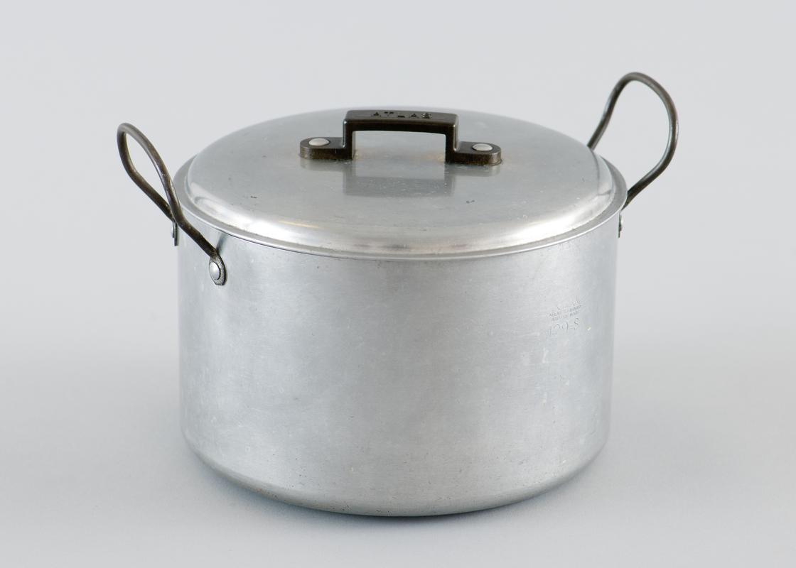 Aluminium saucepan with removable lid, and metal handles either side. Plastic handle on lid with makers name emobssed across center.