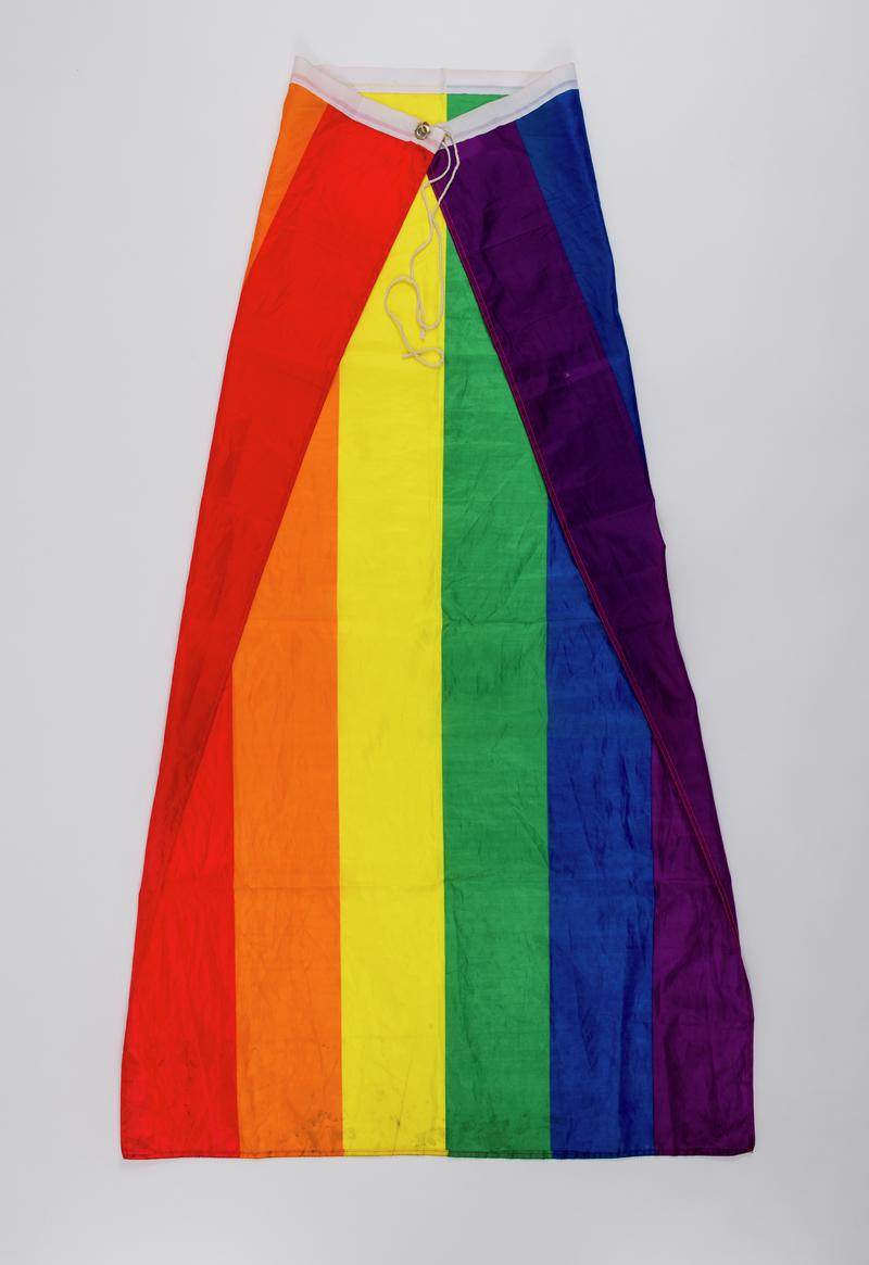 Pride rainbow flag worn as a cape by Numair Masud at various Pride's including first Welsh BAME Pride held on 10 August 2019.