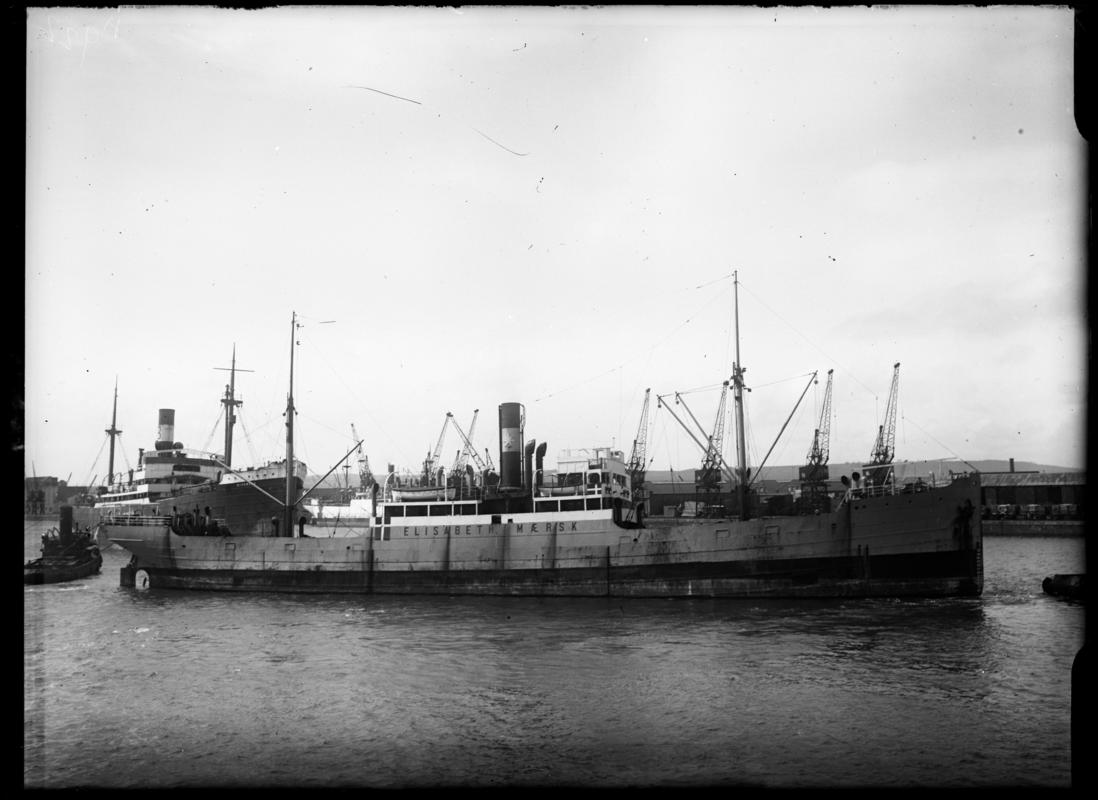Starboard broadside view of S.S. ELISABETH MAERSK with tug and cargo vessel, Cardiff Docks, c.1936.