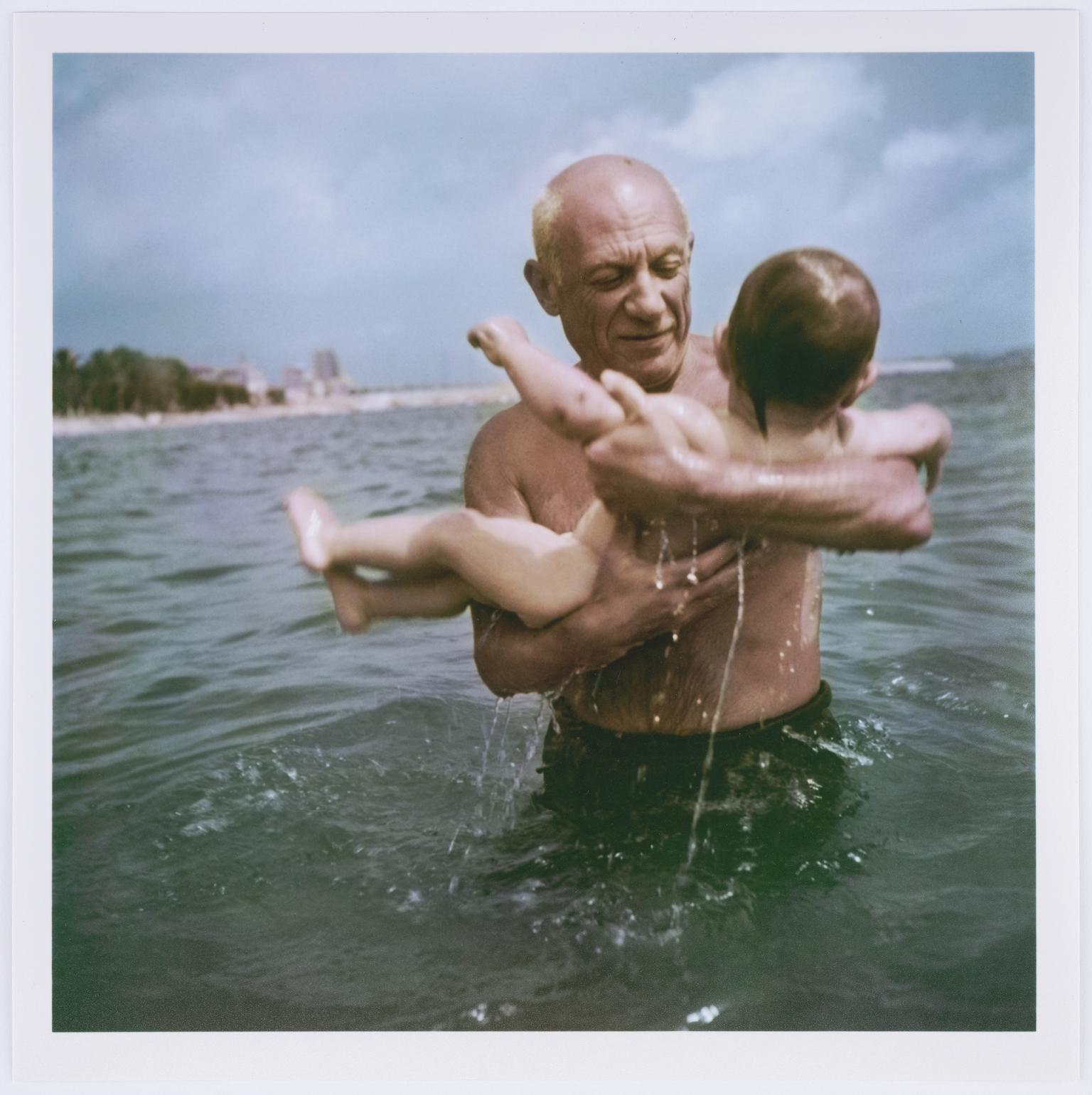 Pablo Picasso playing in the water with his son Claude, Vallauris, France