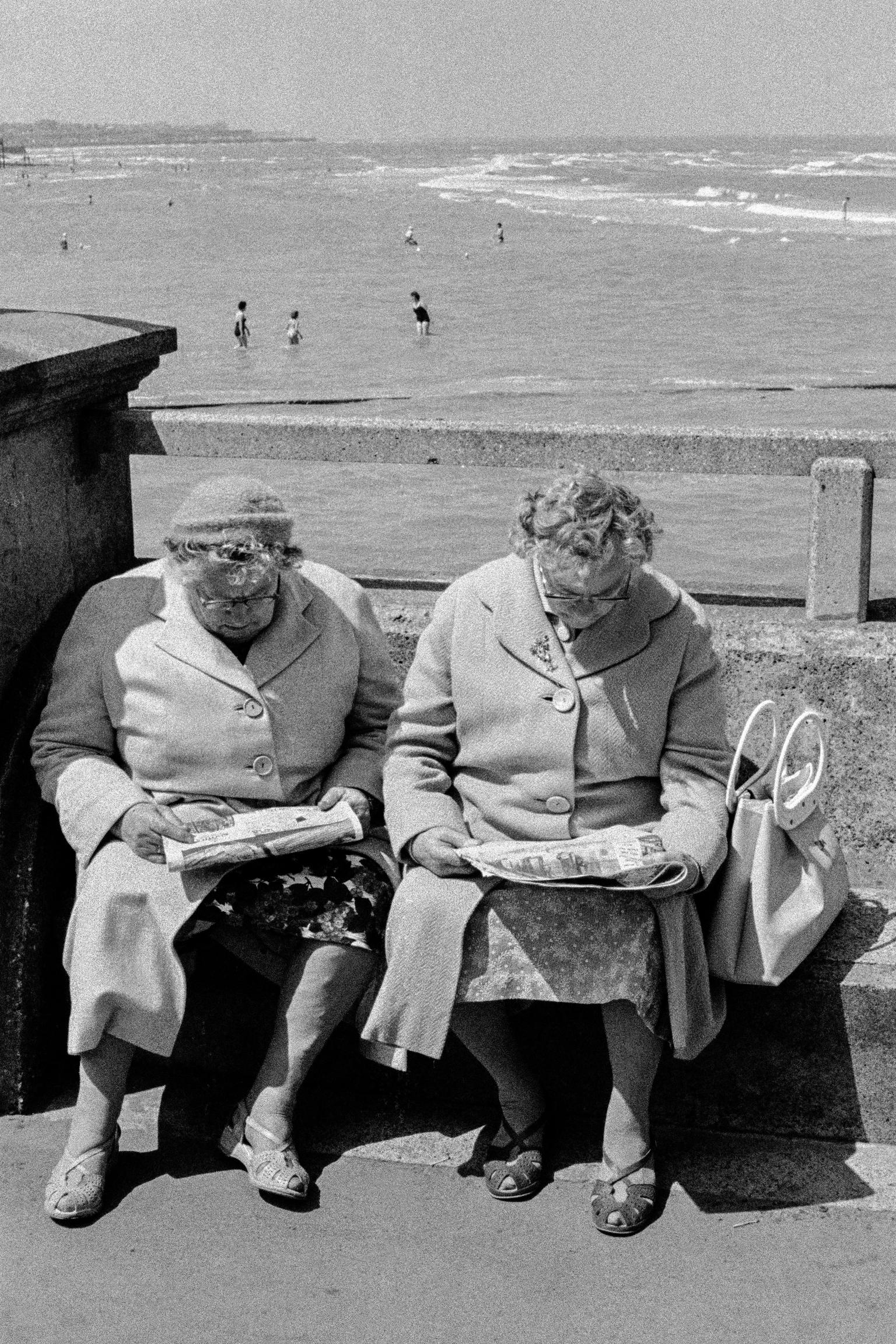 Reading on the seafront. Herne Bay, UK