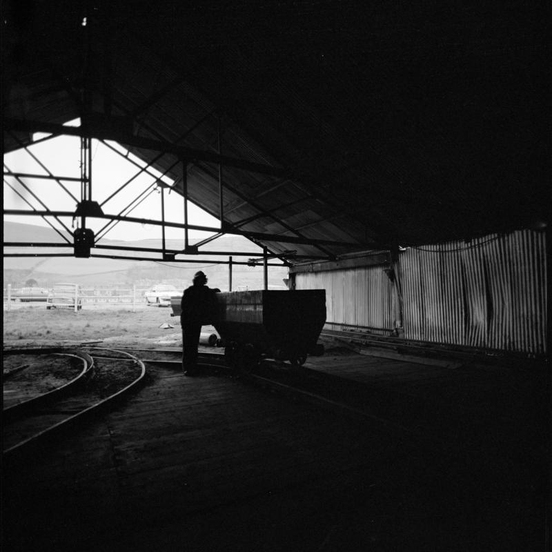 Black and white film negative showing man at the tub circuit, Coegnant Colliery 25 November 1981.  '25 Nov 1981' is transcribed from original negative bag.