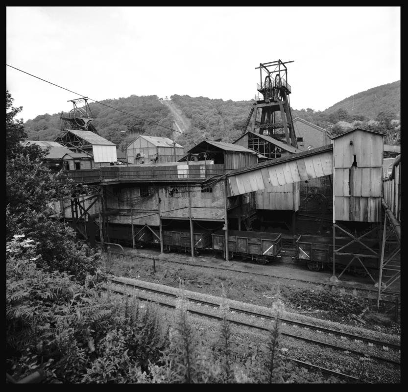 Black and white film negative showing a surface view of Celynen South Colliery, 1978. The headframe was built by E.Finch & Co of Chepstow.