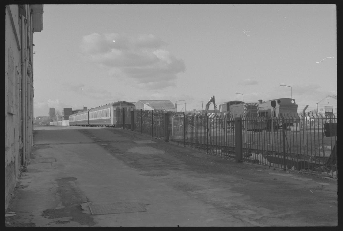 Bute Road Station with old station building on the left, and a passenger train with 2 locomotives (B.H.R.S) on the right.