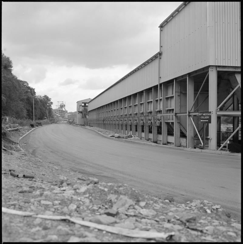 Black and white film negative showing Trelewis Mine buildings with Taff Merthyr Colliery in the background.  'Trelewis' is transcribed from original negative bag.