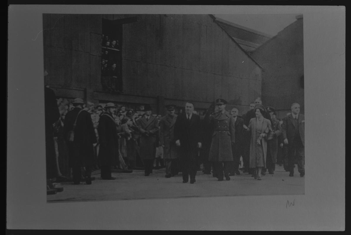 Film negative of a photograph showing visit of King George VI and Queen Elizabeth to Currans, Butetown during World War II.