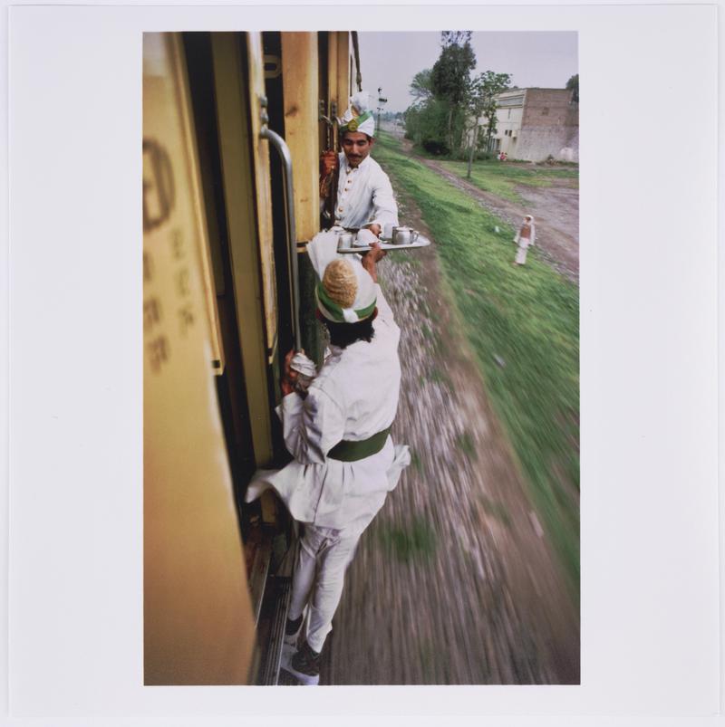 Breakfast Tea being passed between cars on the railway between Peshawar and Lahore. Pakistan