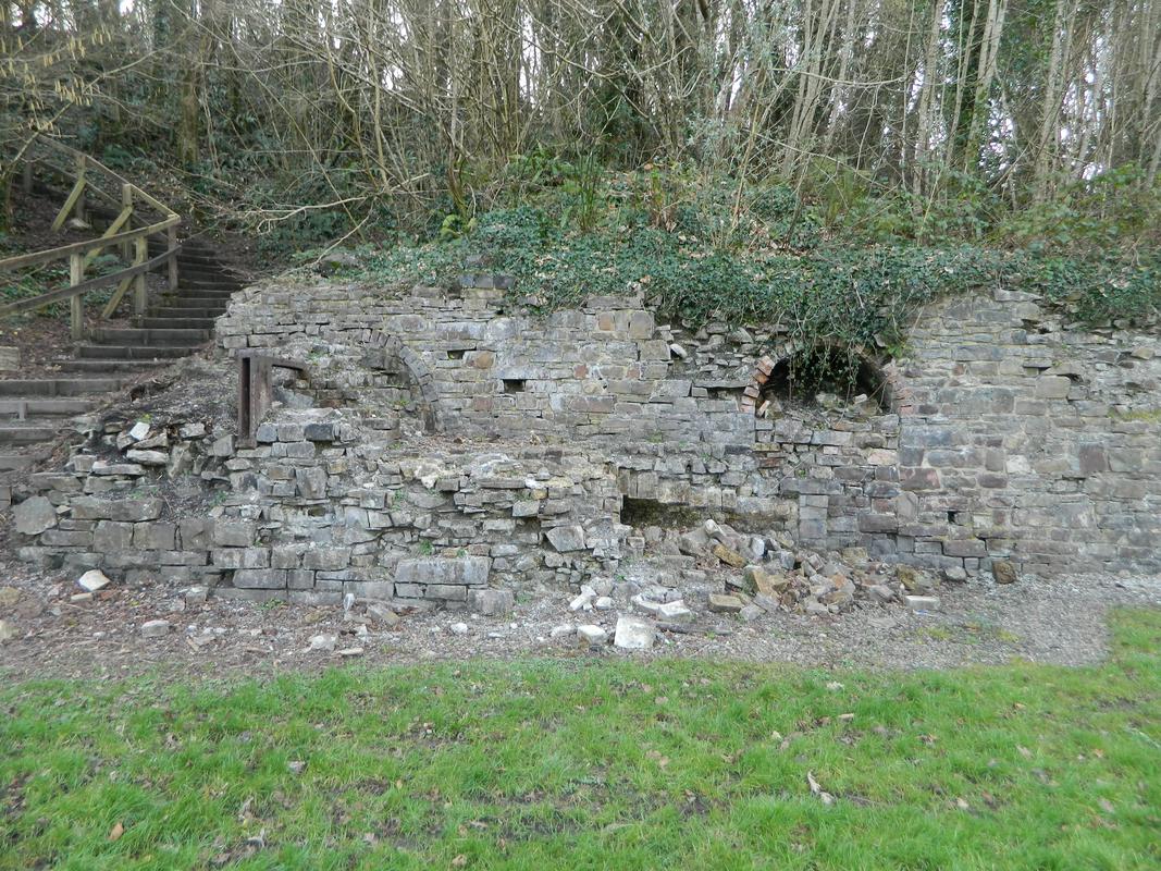 Kilgetty Ironworks, Stepaside: panorama (joins with 28) of ruinous front elevation of block of beehive coke ovens, viewed from east: left hand half of panorama.