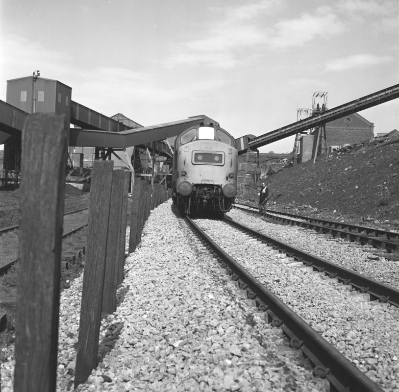Black and white film negative showing a locomotive passing through Oakdale Colliery, 16 April 1981.  'Oakdale 16 Apr 1981' is transcribed from original negative bag.