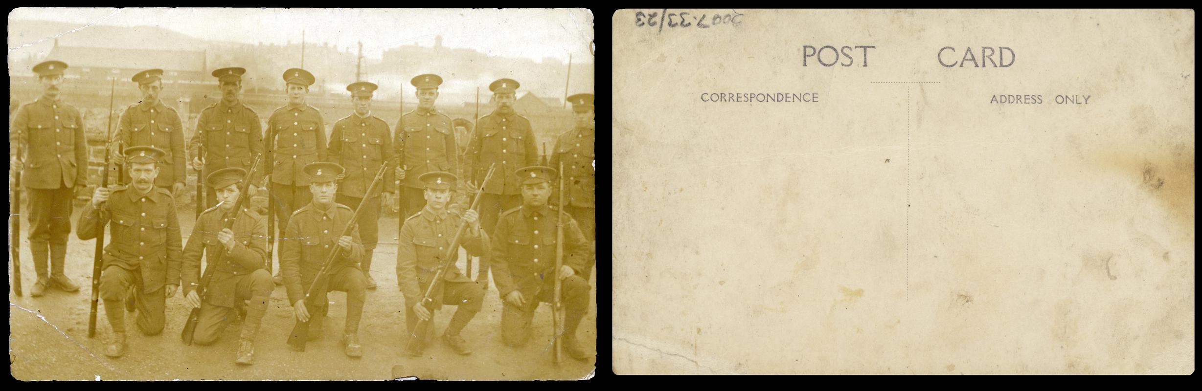 Group of 13 soldiers holding rifles (front & Back)