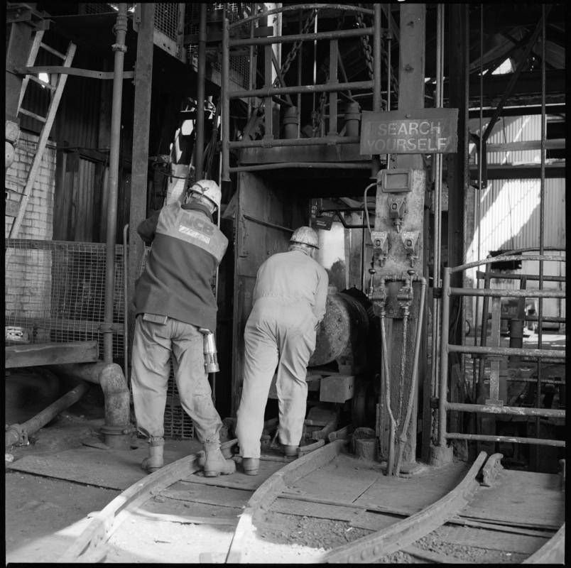 Black and white film negative showing men at pit top, Morlais Colliery 13 May 1981.  'Morlais 13/5/81' is transcribed from original negative bag.