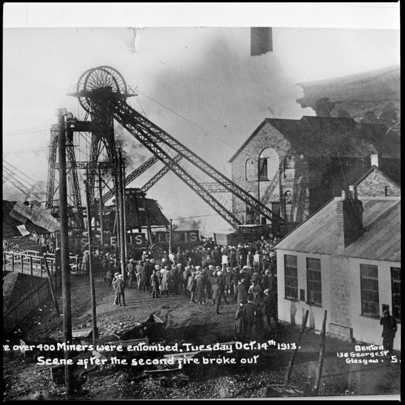 Black and white film negative of a photograph showing the scene at Universal Colliery, Senghenydd after the explosion of 14 October 1913.  Caption on photograph reads 'Over 400 miners were entombed, Tuesday Oct 14th 1913.  Scene after the second fire broke out'. 'Senghenydd' is transcribed from original negative bag.