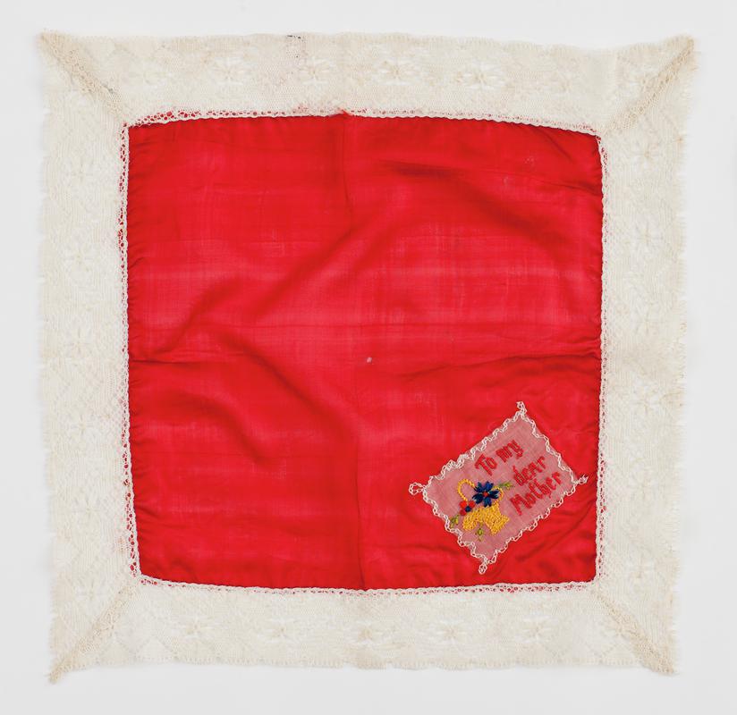 Red silk handkerchief embroidered with the inscription 'To my dear Mother'.