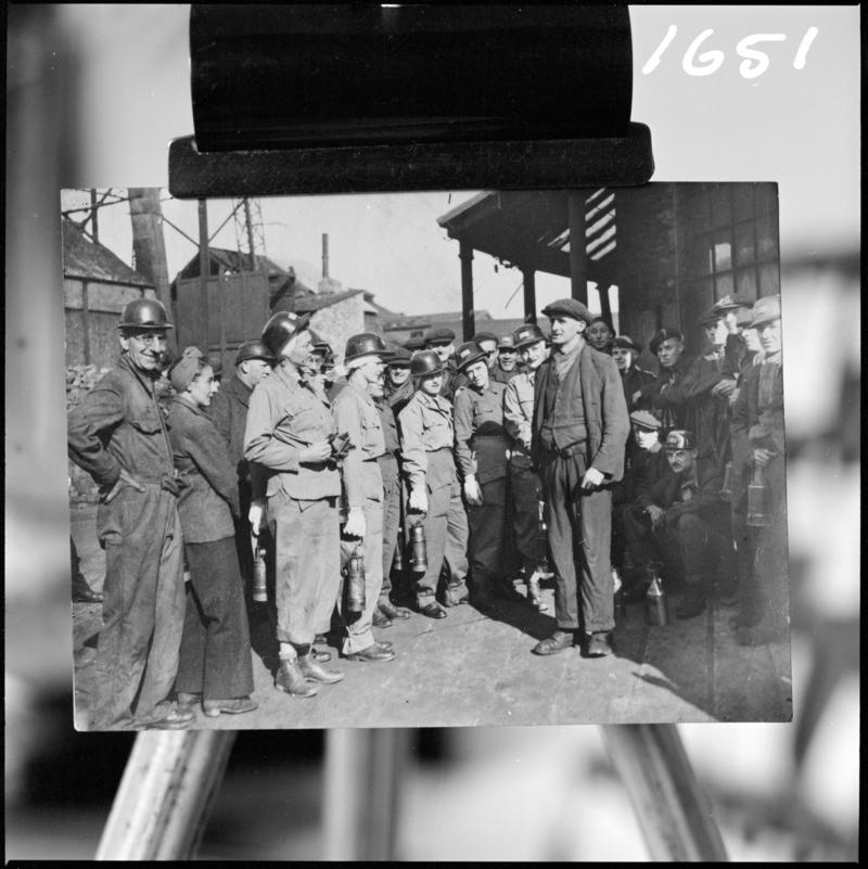 Black and white film negative of a photograph showing a group of men at pit top, Deep Navigation Colliery.