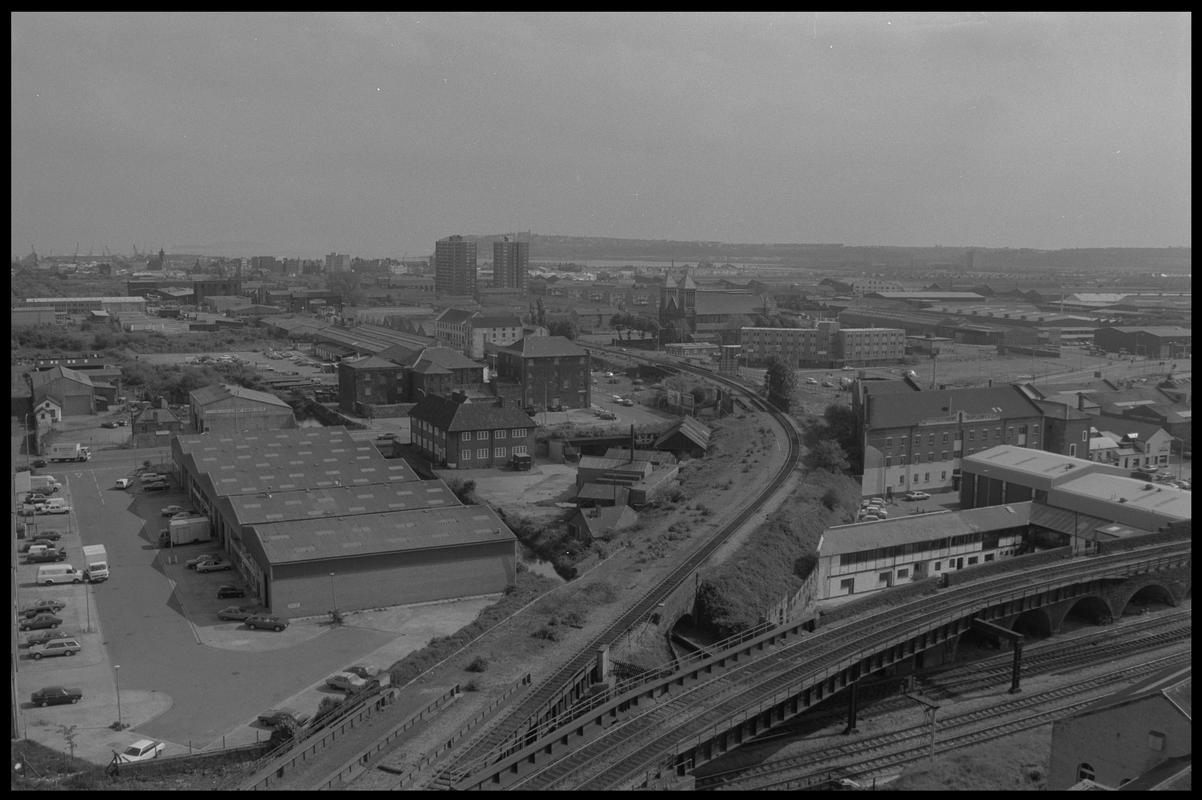 View of Butetown from Bute Terrace, with railway junction from Queen Street and main line in foreground, and flats with Penarth Head in background. Tyndall Street Industrial Area is on the right.