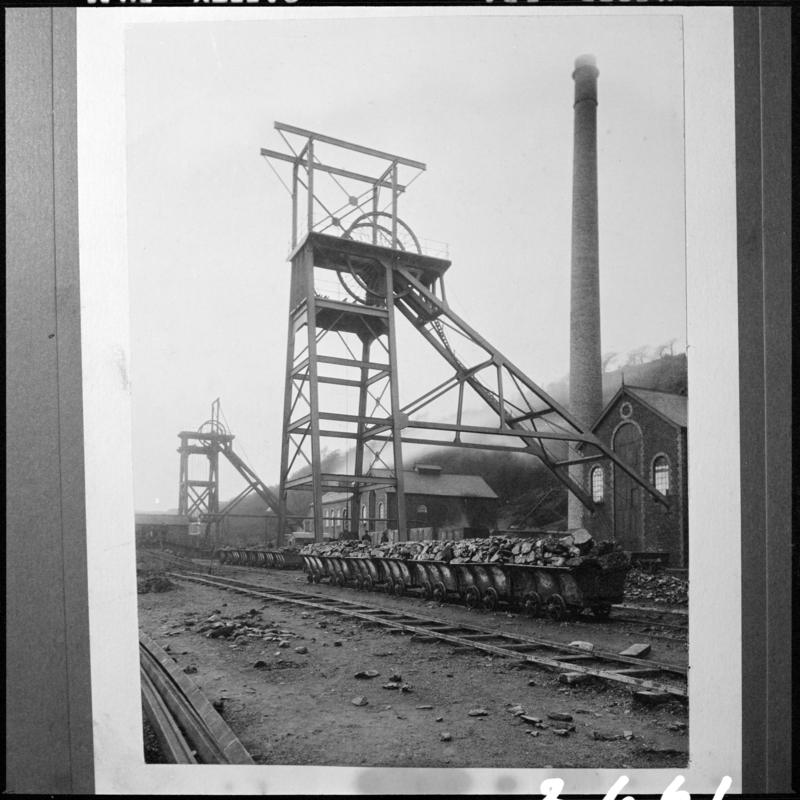 Black and white film negative of a photograph showing a view of the Main Colliery headgears, Skewen.  'Main Colliery' is transcribed from original negative bag.