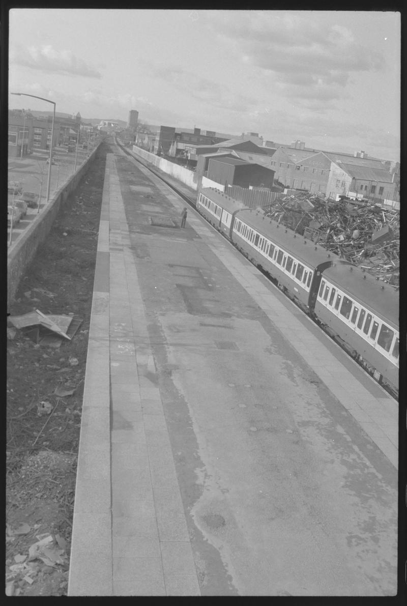 View along Bute Road Station platform towards town, with train alongside.