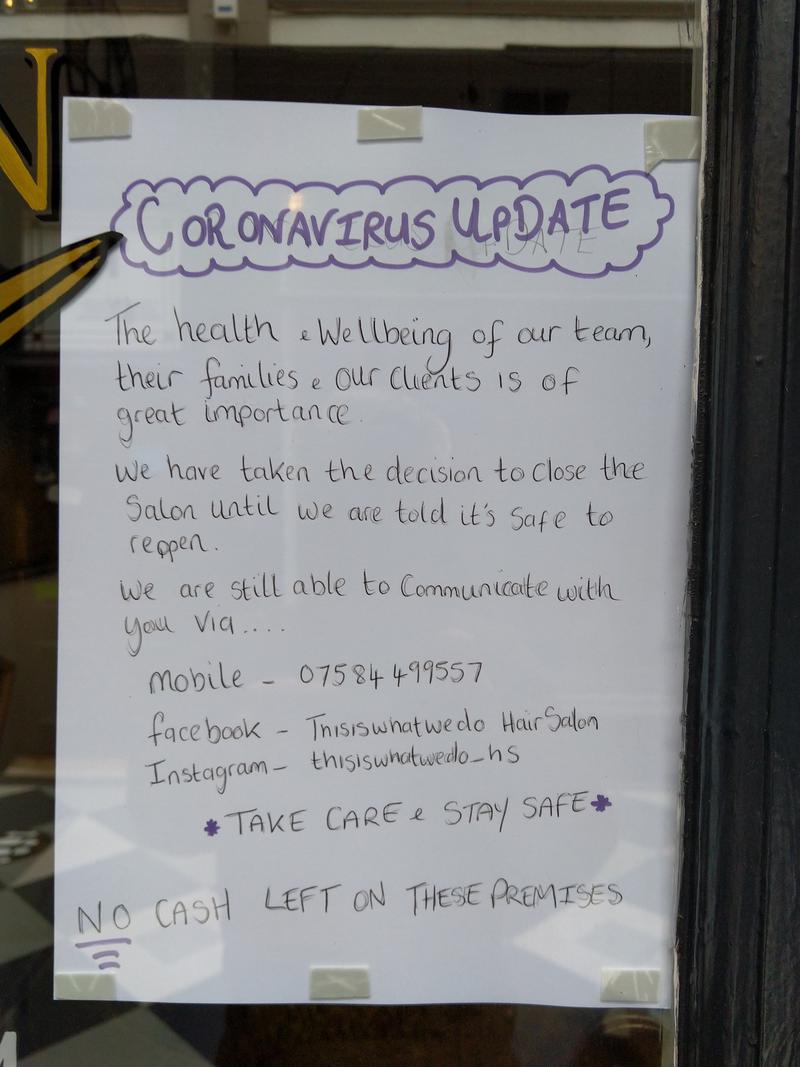 'Coronavirus Update' notice on the door of a hairdressers in High Street Arcade, Cardiff.