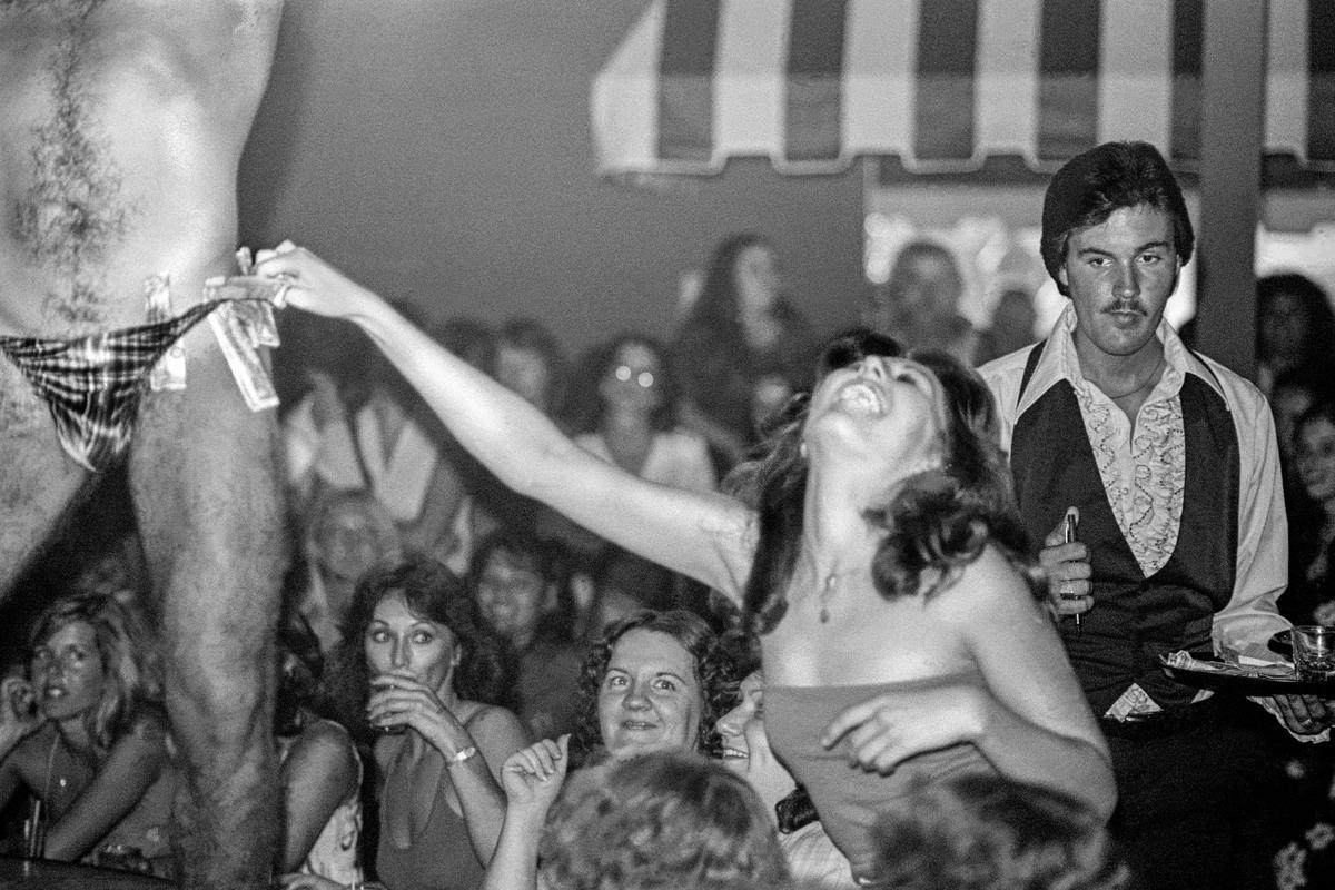 USA. ARIZONA. Phoenix  "Cheeks" a ladies only club just outside the city limits of Phoenix.  Male strippers are the main entertainment of the evening. 1980.