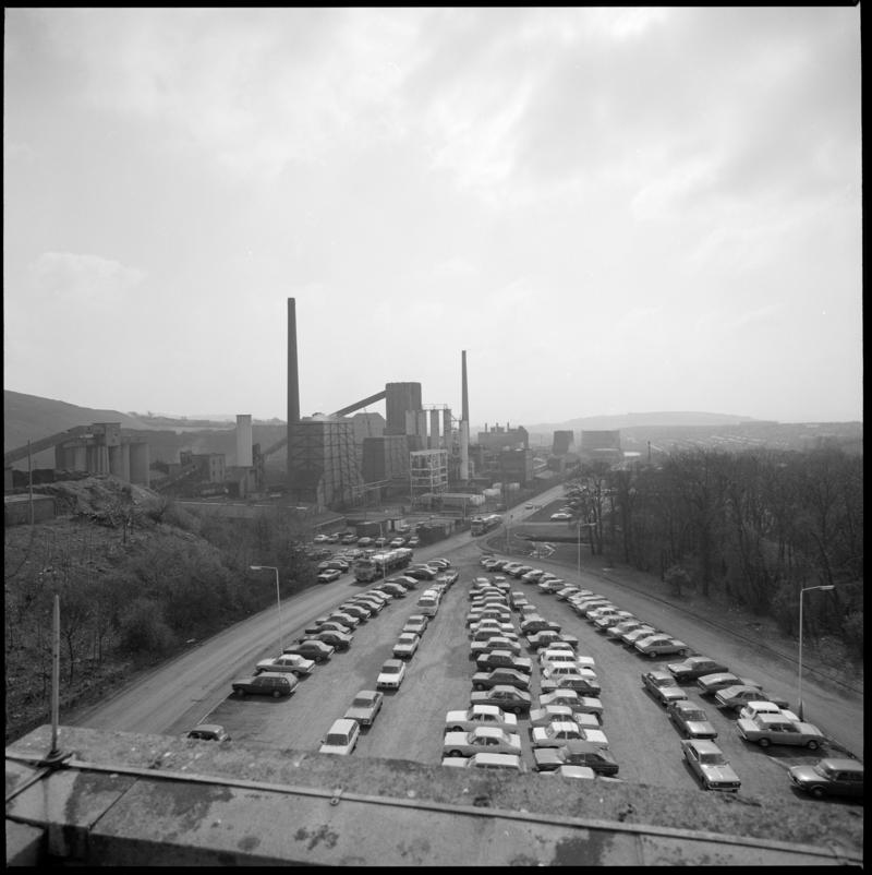 Black and white film negative showing car park and view towards Cwm Colliery.