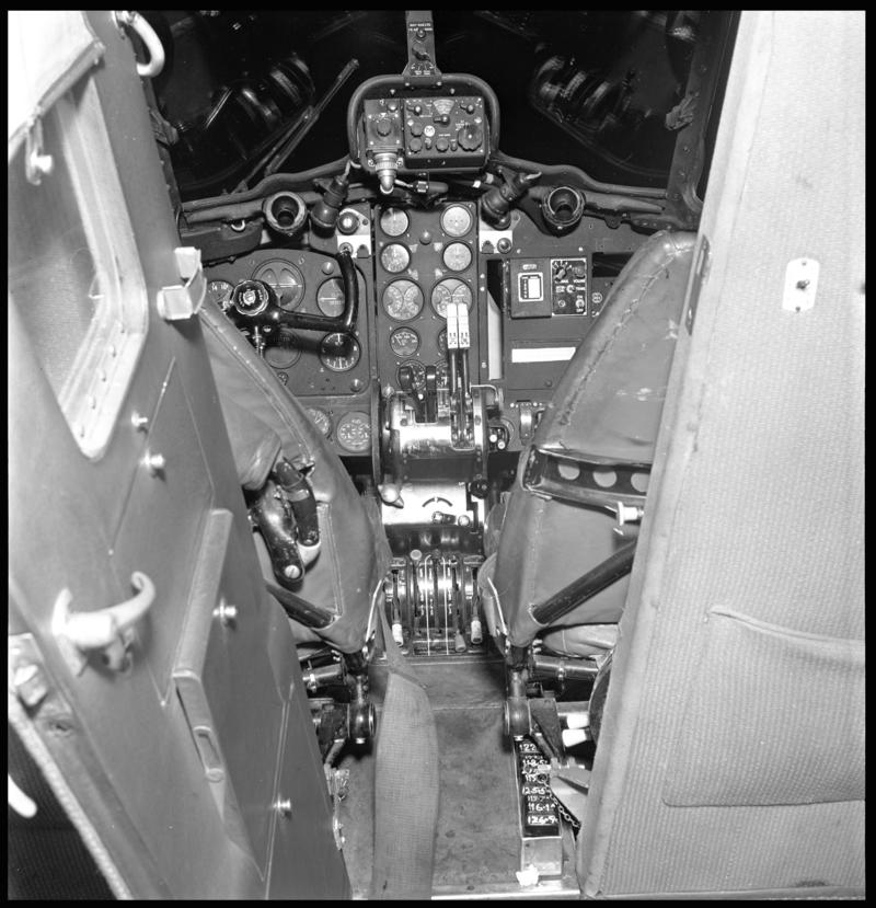 View into the cockpit from the passenger cabin of a Cambrian Air Services' De Havilland Dove aircraft.