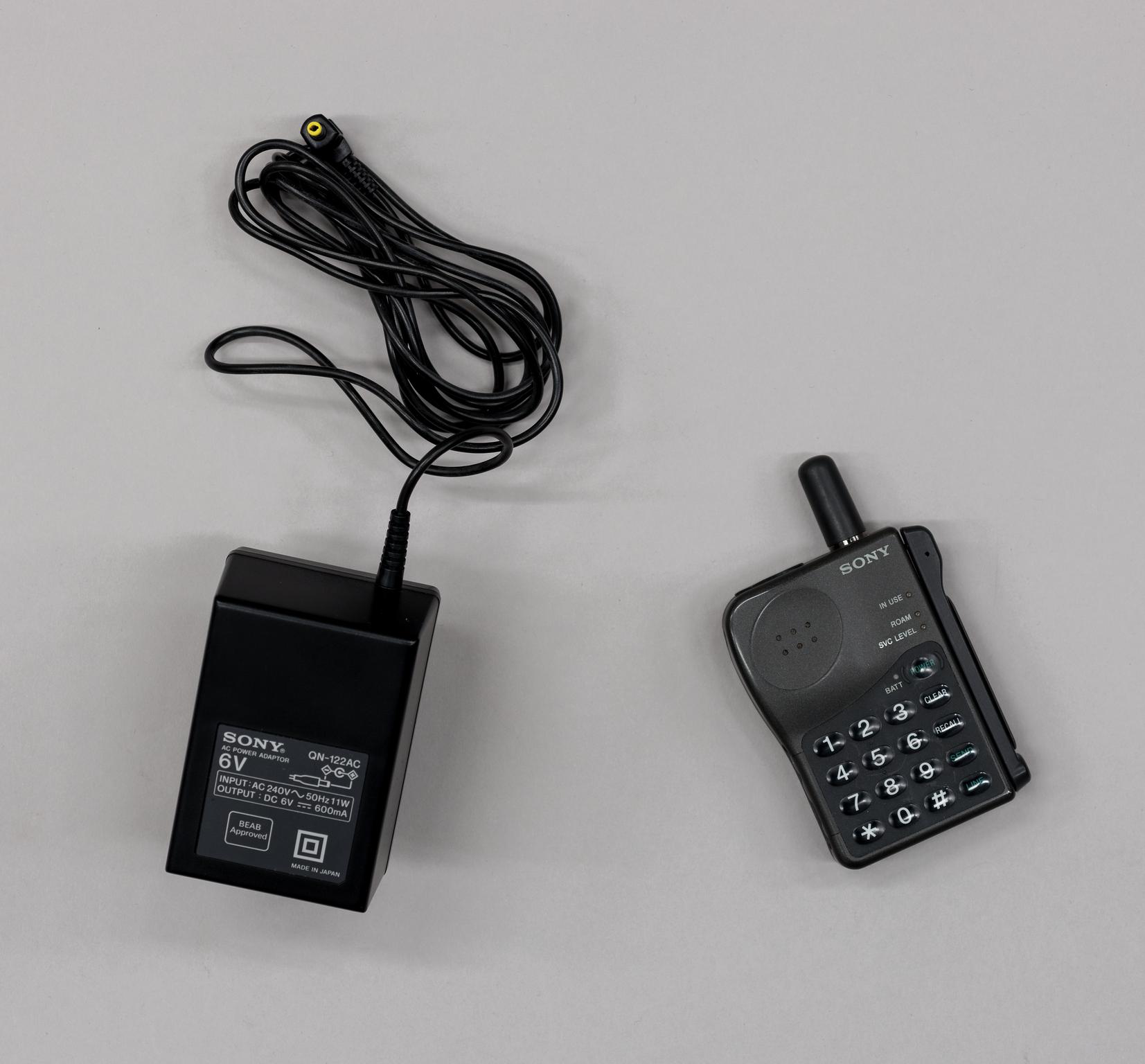 Sony CM-R111 mobile phone and Adaptor for Sony CM-R111 mobile phone.