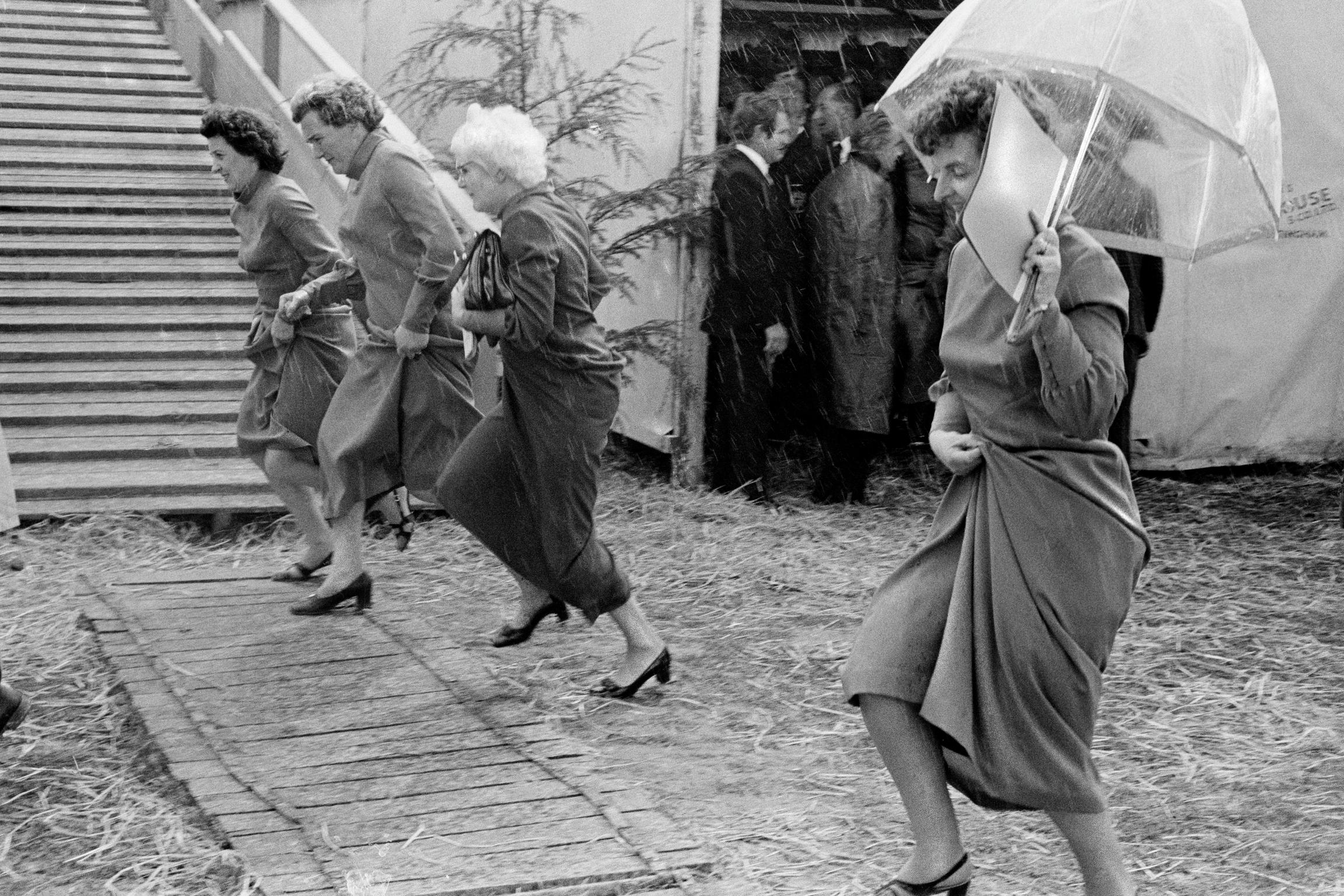 Running in the rain. Competitors in the National Eisteddfod. Ruthin, Wales
