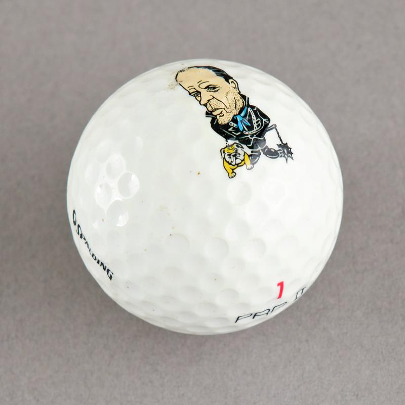 Golf ball with caricature of Norman Tebbit. Sold during 1984-85 Miners' Strike.