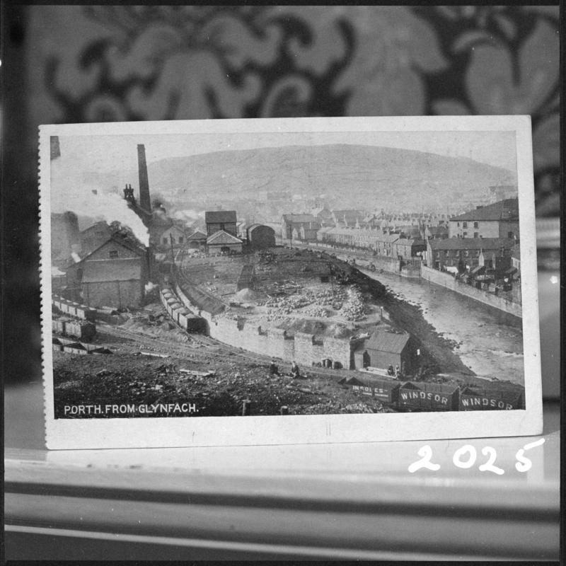 Black and white film negative of a photograph showing a landscape view of Cymmer Colliery, Porth, taken from Glynfach.  'Cymmer' is transcribed from original negative bag.