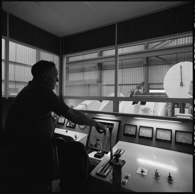 Black and white film negative showing the winding engine driver's cab, Betws Mine.