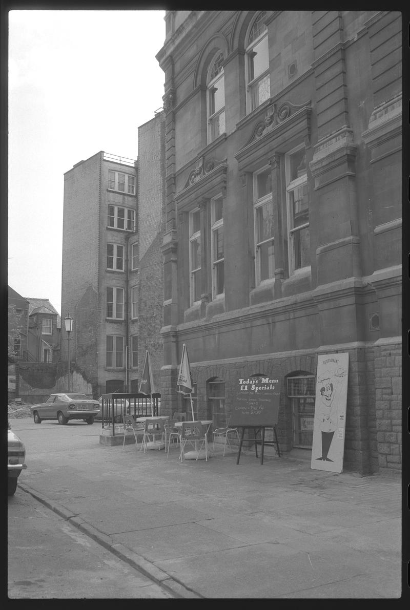 South east corner of Exchange Building, with tables belonging to the Exchange restaurant on pavement, Mount Stuart Square, Butetown.