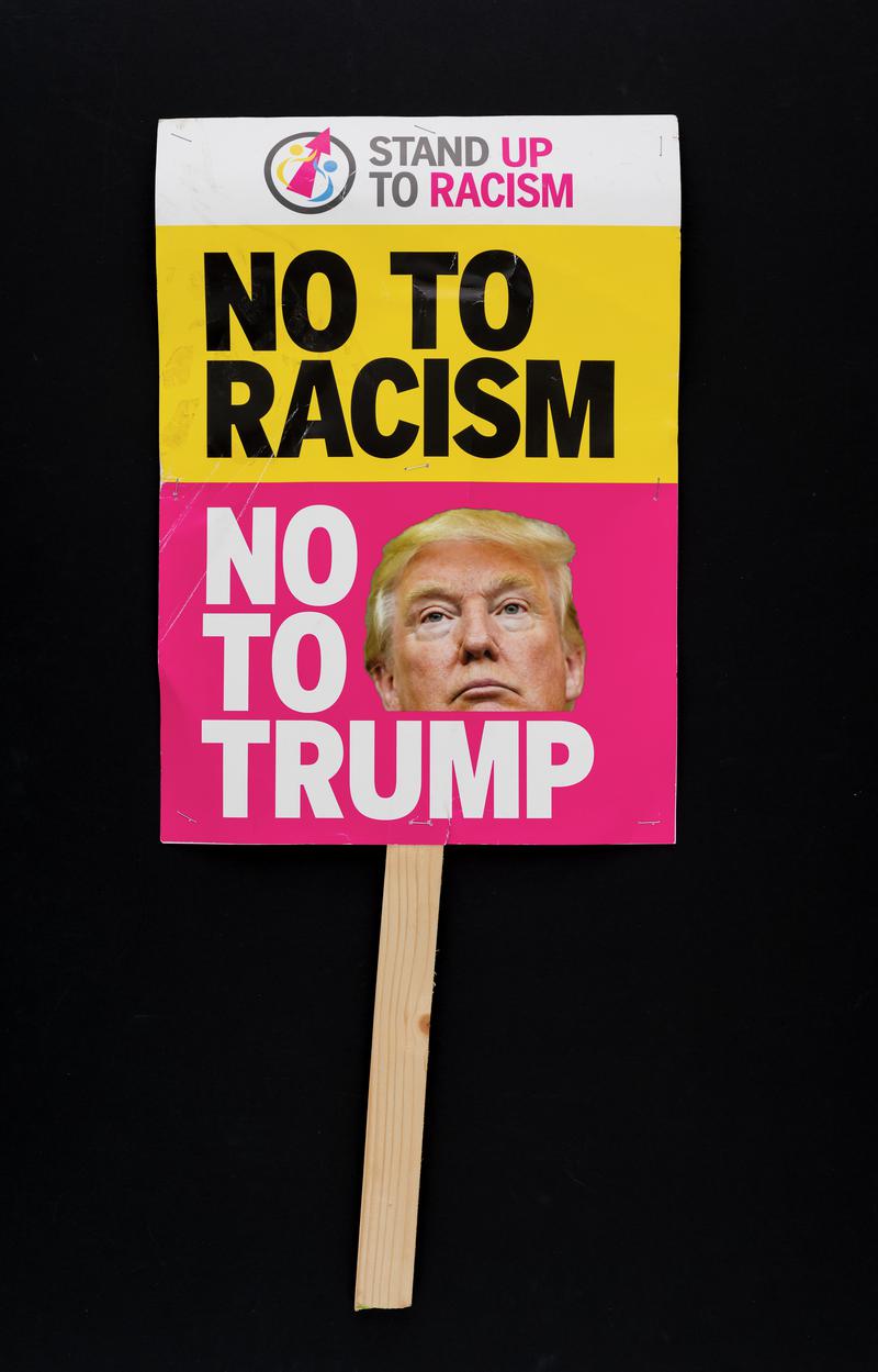 No to Racism. No to Trump' placard used at the Anti-Trump protest in Cardiff city centre on 20 February 2018 - the day Parliament debates the state visit of US President Donald Trump. (Obverse)