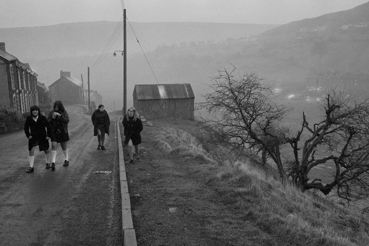 GB. WALES. Abertillery. The morning walk to school in the rain. 1973.