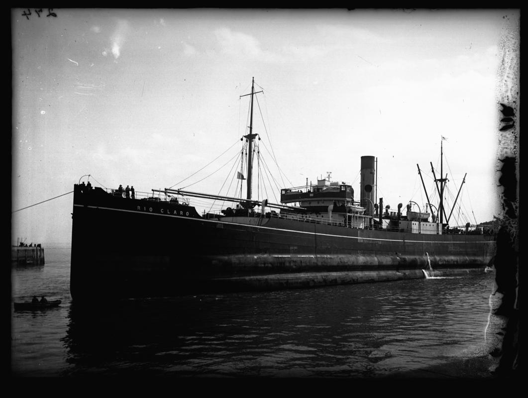 Port broadside view of S.S. RIO CLARO and waterman's boat at Cardiff docks, c.1936.
