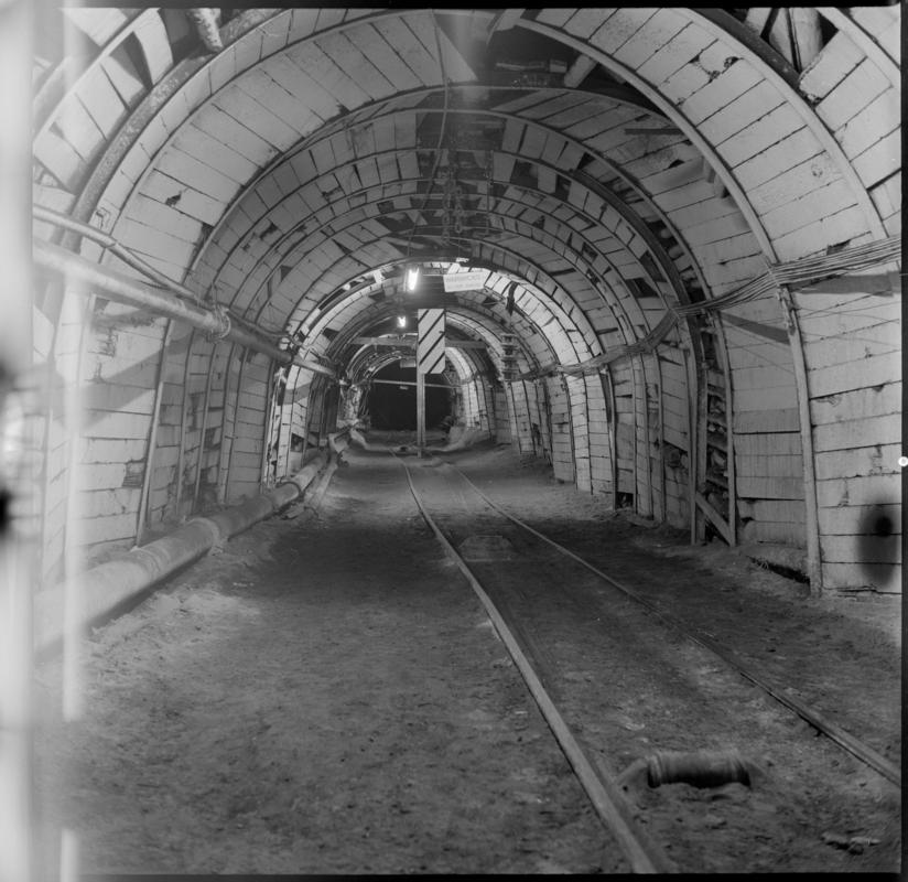 Black and white film negative showing an underground roadway.