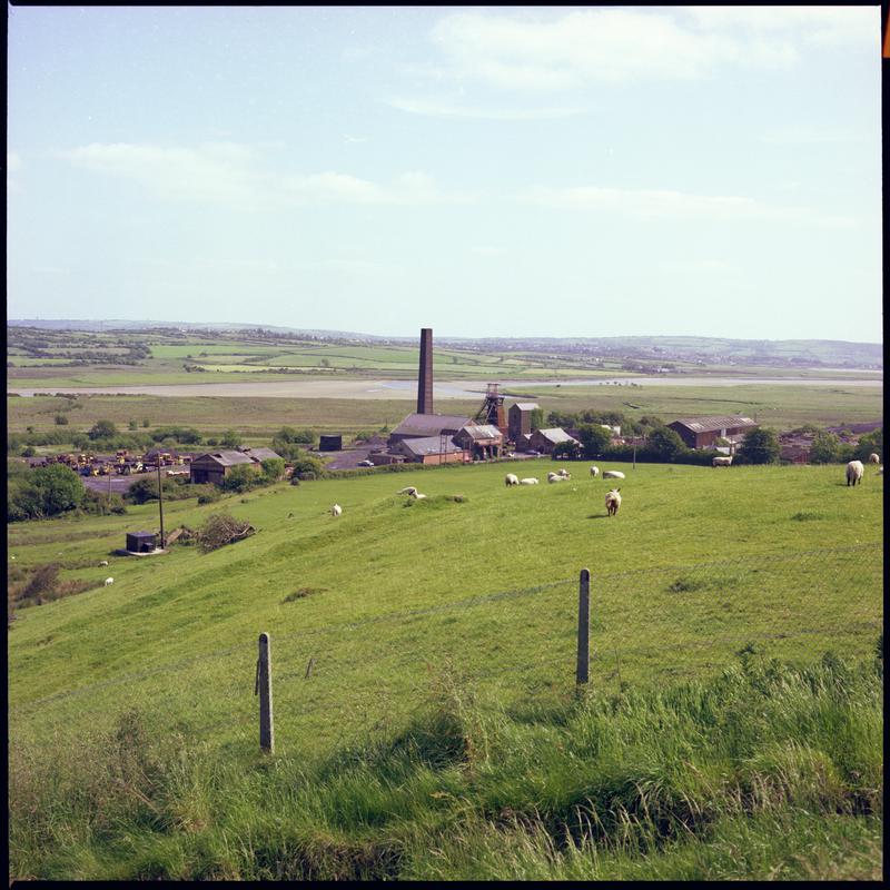 Colour film negative showing a distant surface view of Morlais Colliery. 'Morlais' is transcribed from original negative bag.