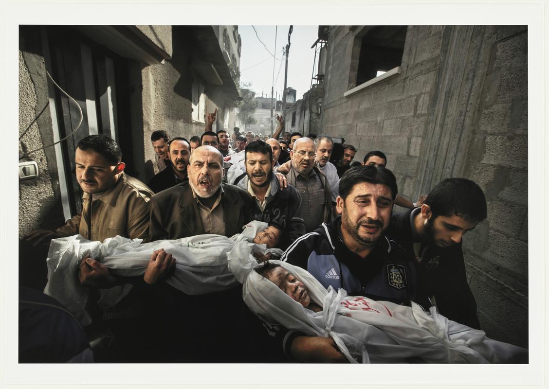 Gaza Burial. The bodies of two-year-old Suhaib Hijazi and his elder brother Muhammad, almost four, are carried by their uncles to a mosque for their funeral