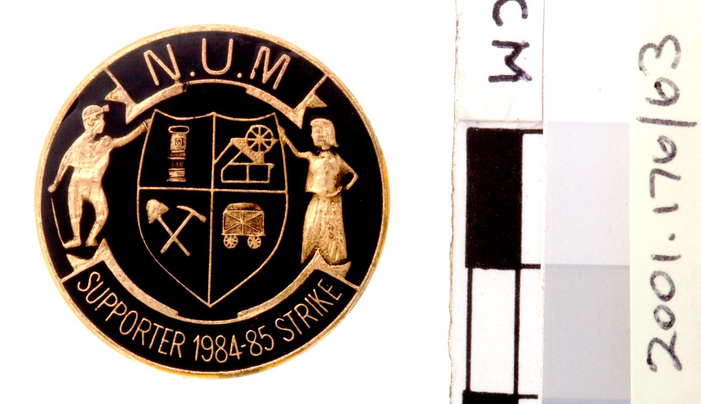 N.U.M. badge