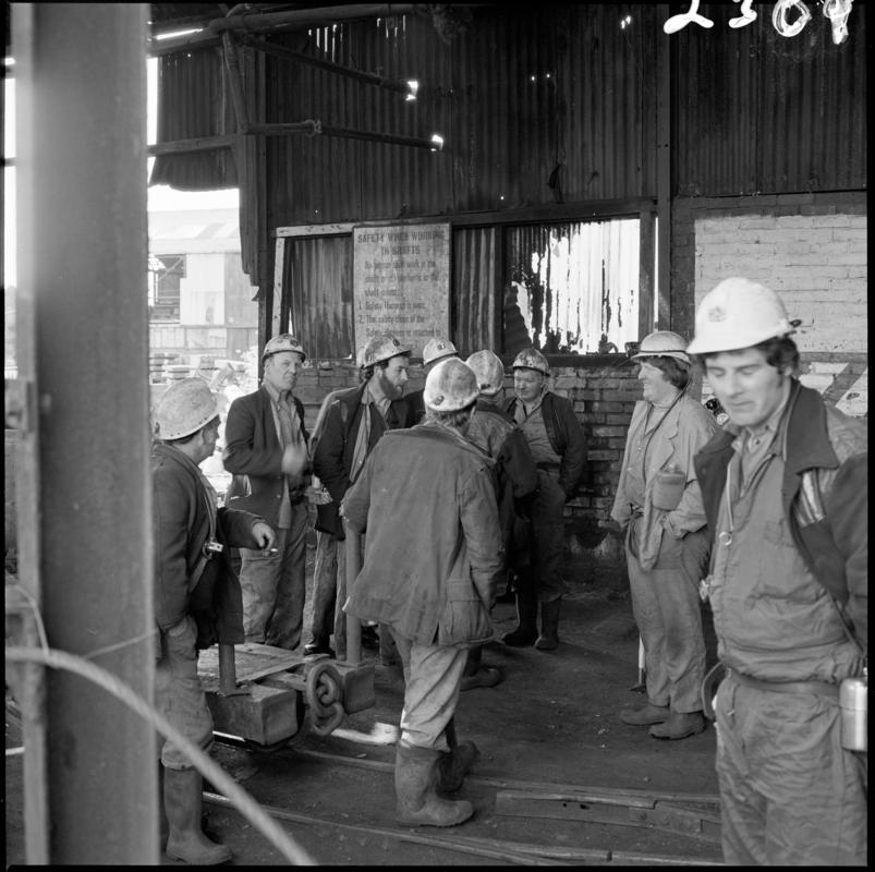 Black and white film negative showing a group of miners on the surface at Morlais Colliery, 13 May 1981.  'Morlais 13/5/81' is transcribed from original negative bag.