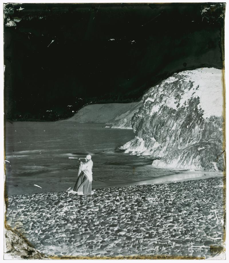 Thereza at Caswell Bay with telescope, glass neg