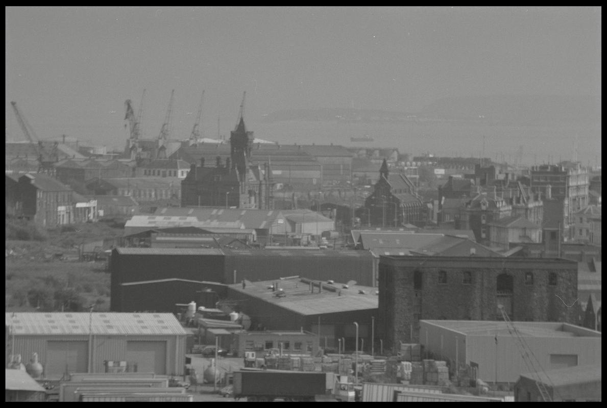 View over Butetown and docks, with Pier Head Building in centre, warehouses etc (Collingdon Road) in foreground and Penarth Head in background.