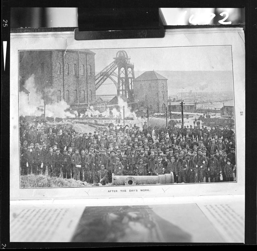 Black and white film negative of a photograph showing a large crowd of workmen 'after the day's work', Deep Navigation Colliery.