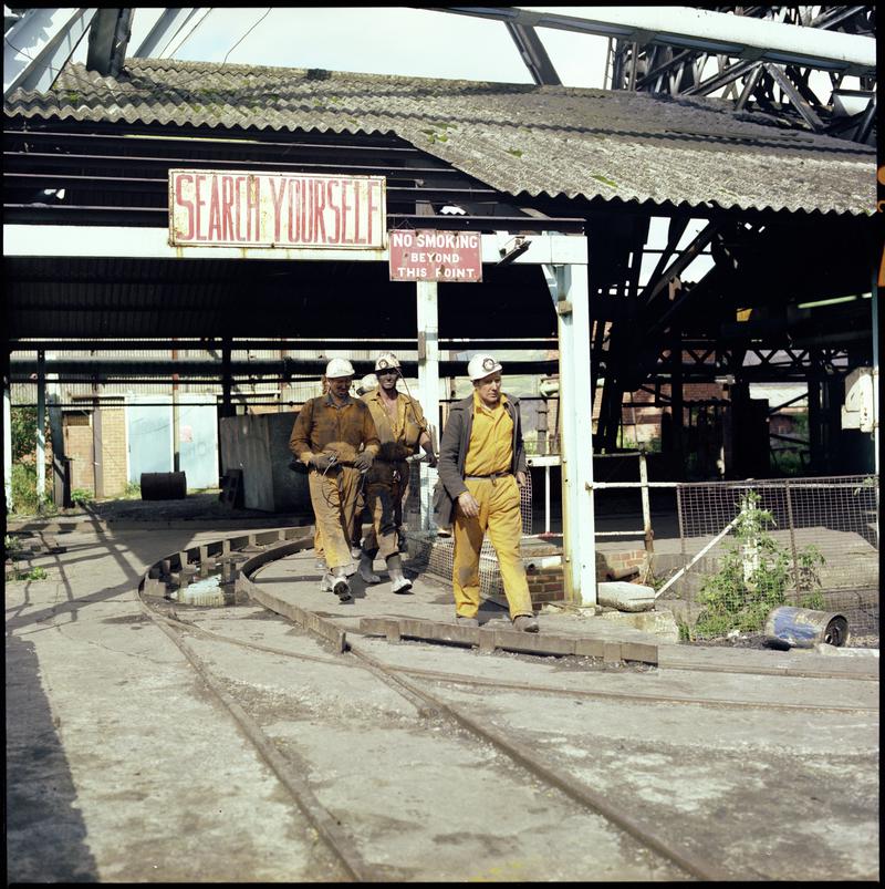 Colour film negative showing miners on the surface, Merthyr Vale Colliery.  'Merthyr Vale' is transcribed from original negative bag.