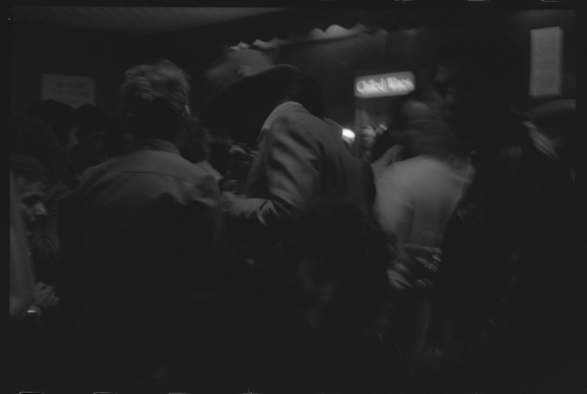 Customers standing near bar in the Dowlais, Butetown.