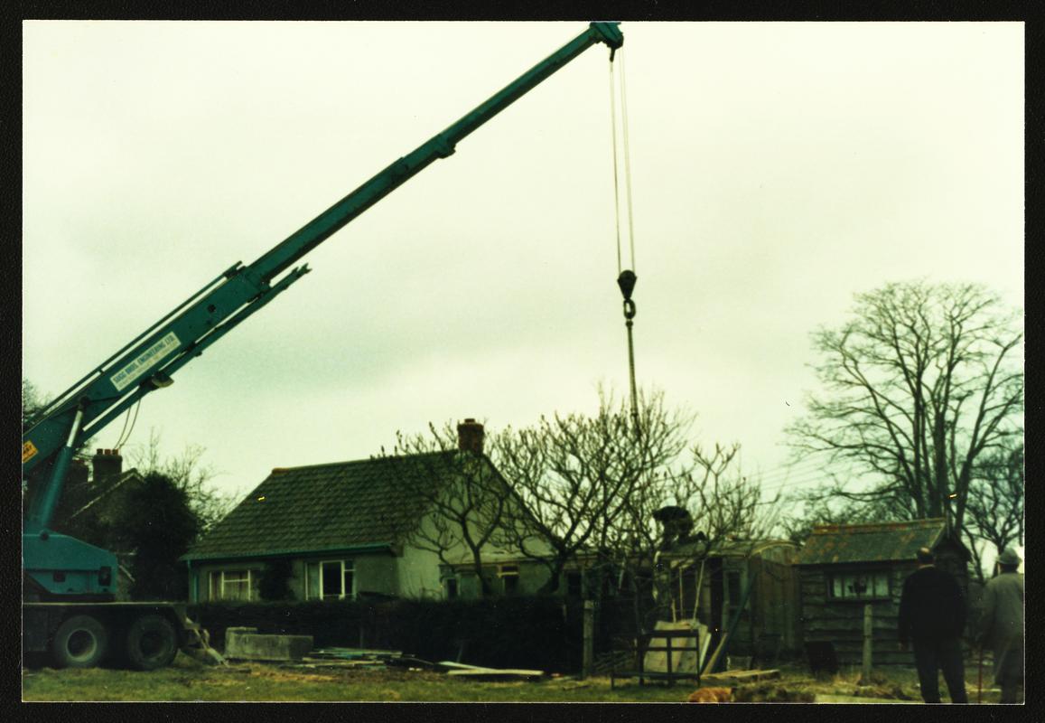 Colour photograph of large crane preparing to lift Cambrian Railways brake/3rd carriage body of c.1890 (acc.no. 87.116I) grounded at Ashcott, Somerset, for movement to Welsh Industrial & Maritime Museum, 1988.