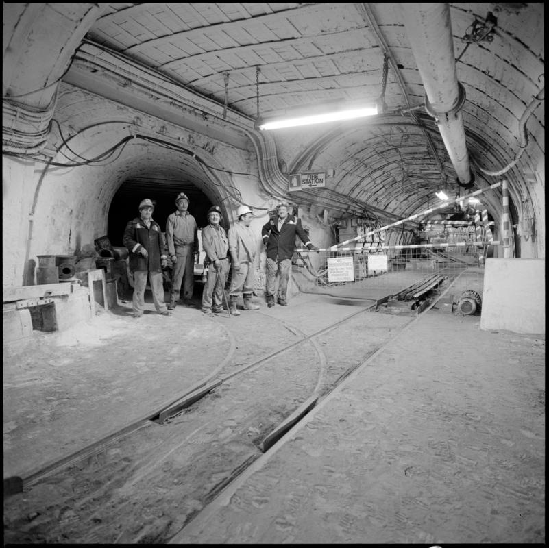 Black and white film negative showing a group of miners underground at Merthyr Vale Colliery, 2 July 1981.  'Merthyr Vale 2 Jul 1981' is transcribed from original negative bag.