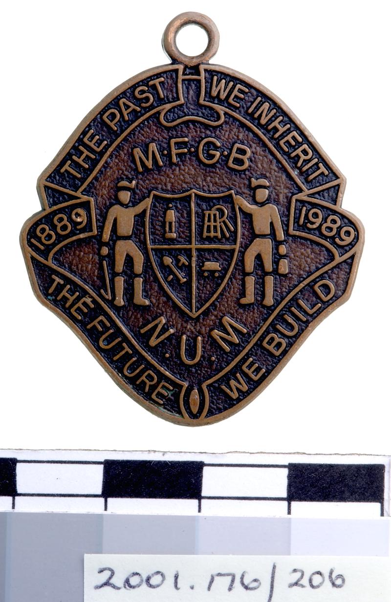 M.F.G.B / N.U.M 1889-1989 badge
