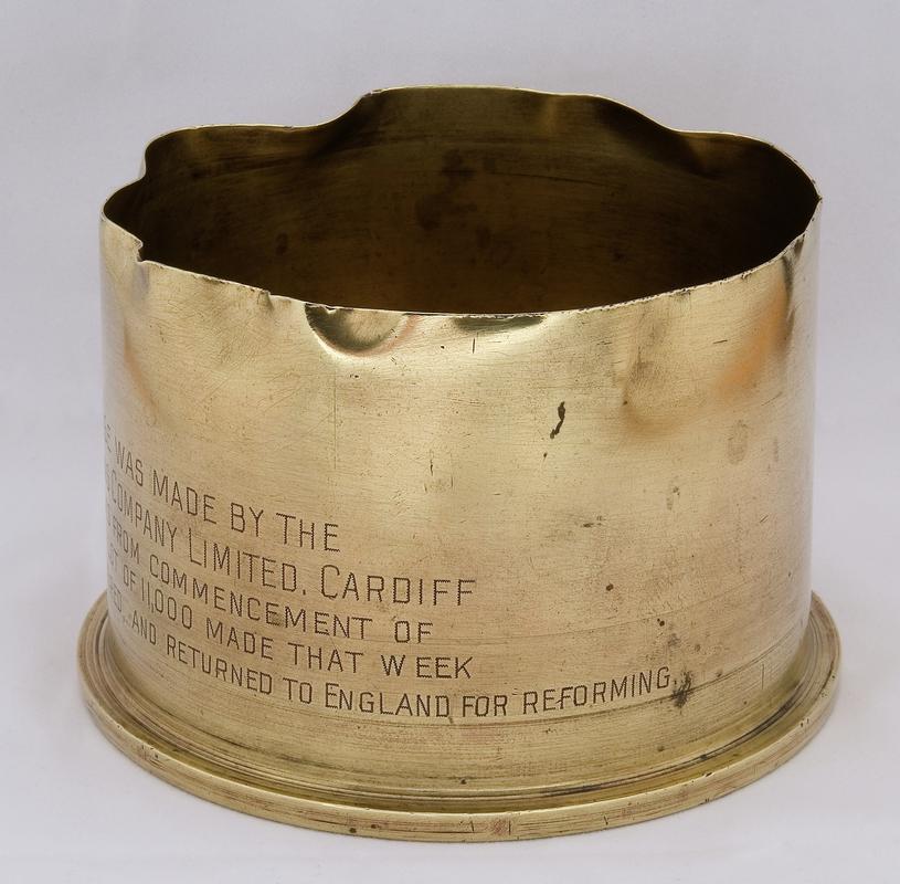 commemorative brass shell case made by Currans of Cardiff, showing inscription around shell body