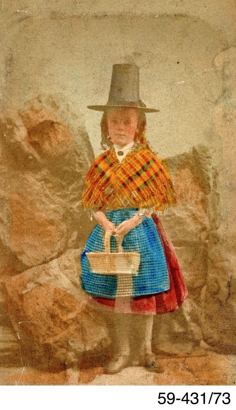 Tinted studio photograph of young girl in Welsh costume